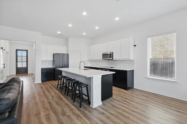3120 Bent Creek Dr, Anna, TX 75409 - kitchen featuring stainless steel appliances, a sink, decorative backsplash, a breakfast bar area, and an island with sink