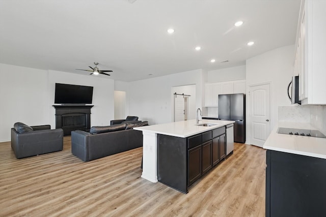 3120 Bent Creek Dr, Anna, TX 75409 - kitchen with appliances with stainless steel finishes, ceiling fan, a sink, light countertops, and white cabinets