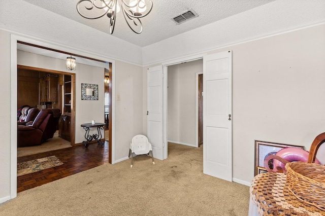 1502 Hinchliffe Rd, Mexia, TX 76667 - living area with baseboards, visible vents, an inviting chandelier, and light colored carpet