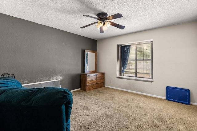 1502 Hinchliffe Rd, Mexia, TX 76667 - carpeted bedroom featuring ceiling fan, baseboards, a textured wall, and a textured ceiling