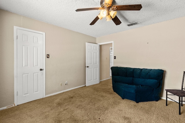1502 Hinchliffe Rd, Mexia, TX 76667 - sitting room featuring visible vents, carpet, a textured ceiling, and ceiling fan