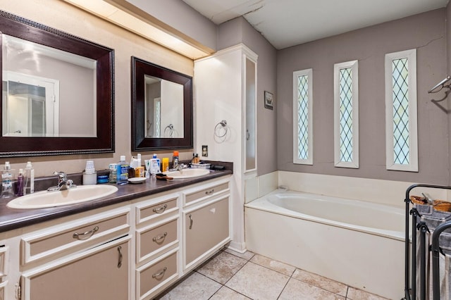 1502 Hinchliffe Rd, Mexia, TX 76667 - bathroom featuring tile patterned flooring, a bath, a sink, and double vanity