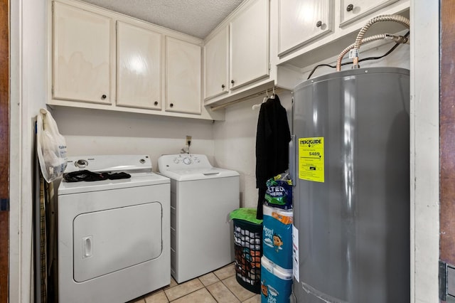 1502 Hinchliffe Rd, Mexia, TX 76667 - clothes washing area featuring water heater, light tile patterned floors, washing machine and clothes dryer, cabinet space, and a textured ceiling
