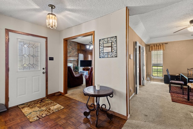 1502 Hinchliffe Rd, Mexia, TX 76667 - entryway with a fireplace, baseboards, a textured ceiling, and ceiling fan with notable chandelier