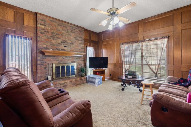 1502 Hinchliffe Rd, Mexia, TX 76667 - carpeted living area with wooden walls, plenty of natural light, a brick fireplace, and a textured ceiling