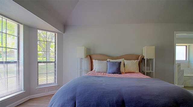 405 Derby Ln, Desoto, TX 75115 - bedroom featuring connected bathroom, lofted ceiling, light wood finished floors, and baseboards