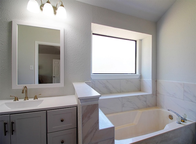 405 Derby Ln, Desoto, TX 75115 - bathroom with a bath, a textured wall, and vanity
