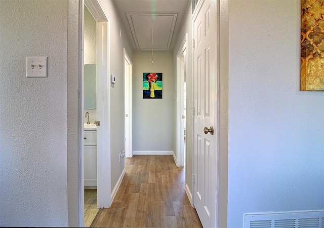 405 Derby Ln, Desoto, TX 75115 - hallway featuring attic access, visible vents, baseboards, wood finished floors, and a textured wall