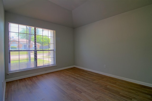 405 Derby Ln, Desoto, TX 75115 - empty room with lofted ceiling, baseboards, and wood finished floors