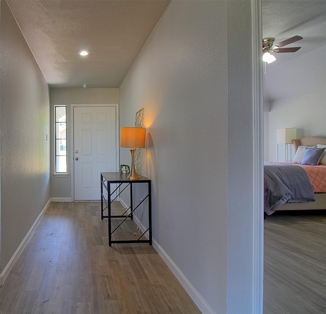 405 Derby Ln, Desoto, TX 75115 - foyer entrance with wood finished floors, a textured wall, baseboards, and ceiling fan