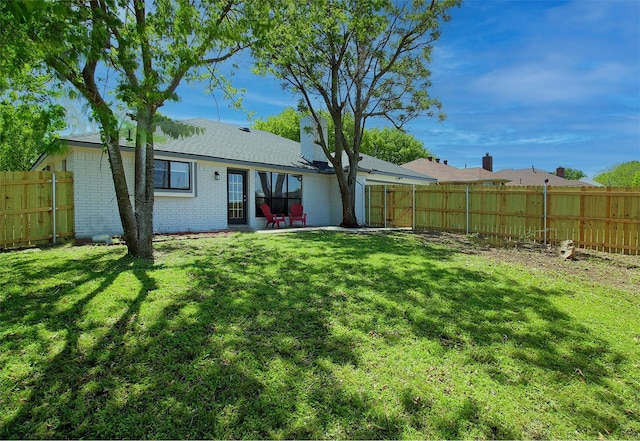405 Derby Ln, Desoto, TX 75115 - back of property featuring brick siding, a yard, and a fenced backyard