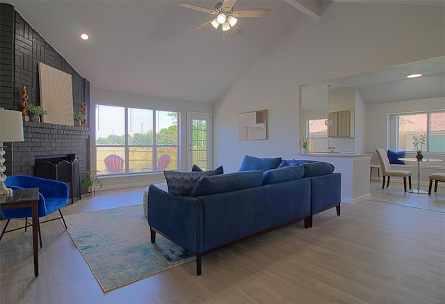 405 Derby Ln, Desoto, TX 75115 - living room featuring high vaulted ceiling, light wood-style flooring, ceiling fan, a fireplace, and beam ceiling