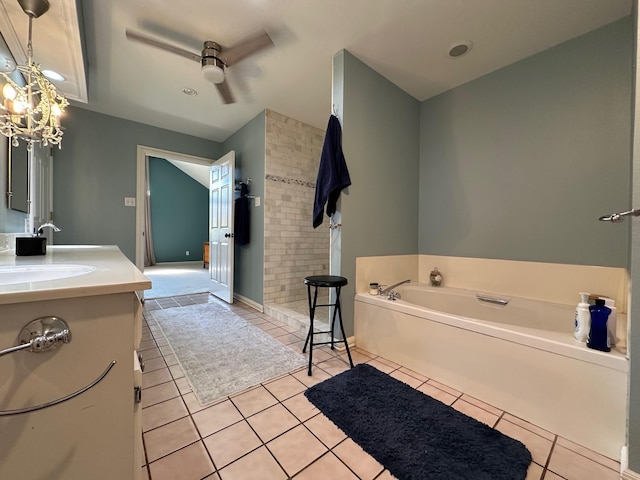 bathroom with a bath, tile patterned flooring, vanity, and a notable chandelier