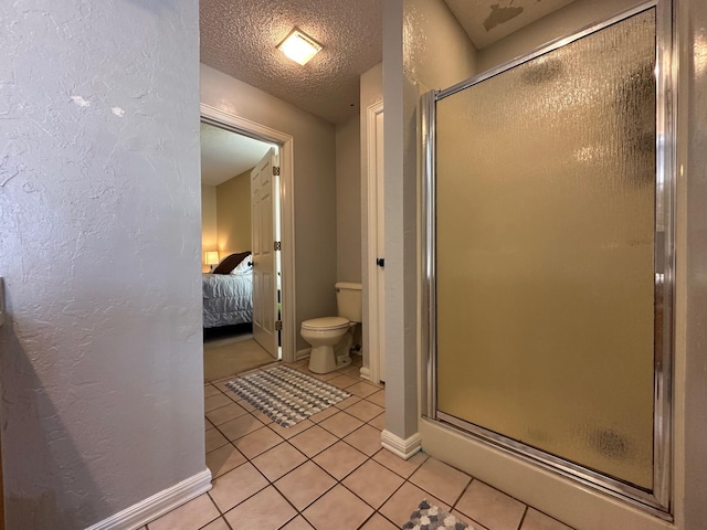 bathroom with toilet, tile patterned floors, ensuite bathroom, and a stall shower