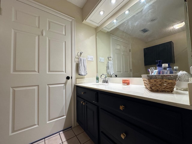 bathroom with visible vents, vanity, and tile patterned flooring