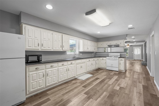 117 W Craven Ave, Lacy Lakeview, TX 76705 - kitchen with white appliances, white cabinetry, dark countertops, recessed lighting, and a textured ceiling