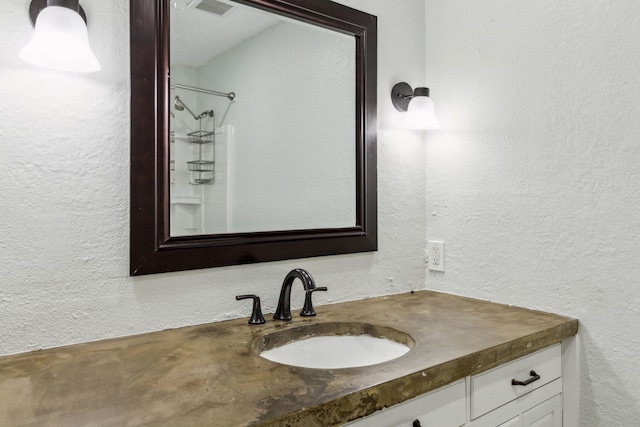 609 Admiralty Way, Fort Worth, TX 76108 - bathroom with visible vents, a textured wall, walk in shower, and vanity