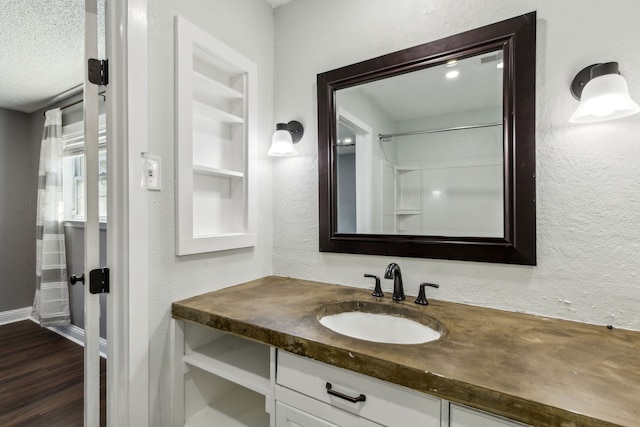 609 Admiralty Way, Fort Worth, TX 76108 - bathroom with baseboards, a textured wall, vanity, and wood finished floors