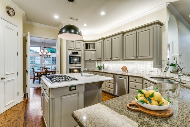 kitchen with a sink, appliances with stainless steel finishes, and gray cabinets