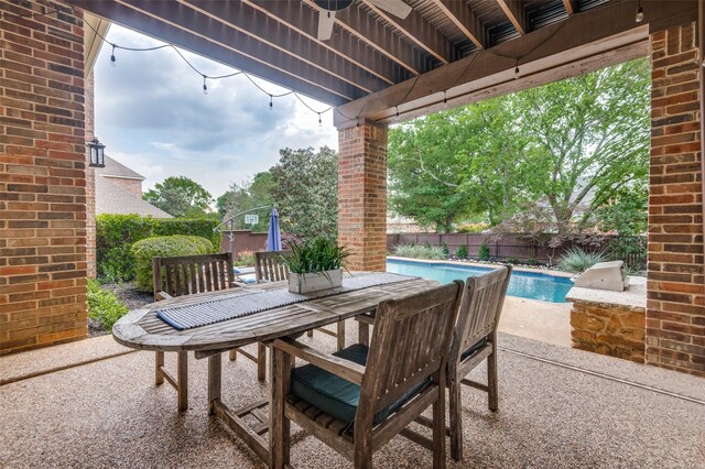 view of patio / terrace with a fenced in pool, outdoor dining area, and a fenced backyard