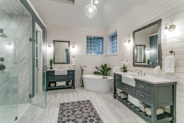 full bath featuring a sink, a soaking tub, vaulted ceiling, and a shower stall