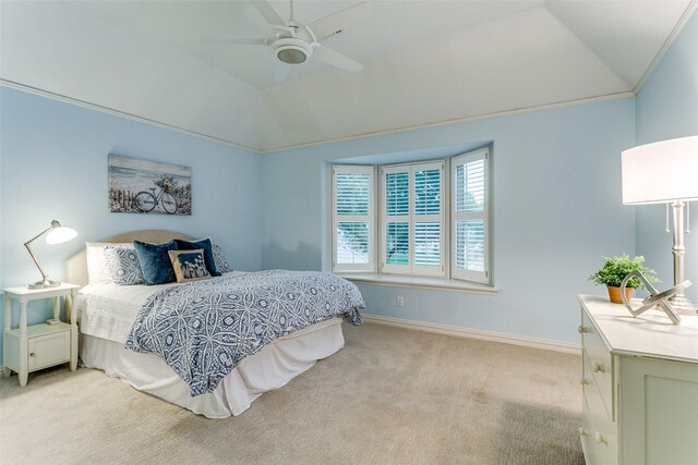 bedroom with light colored carpet, baseboards, vaulted ceiling, and a ceiling fan