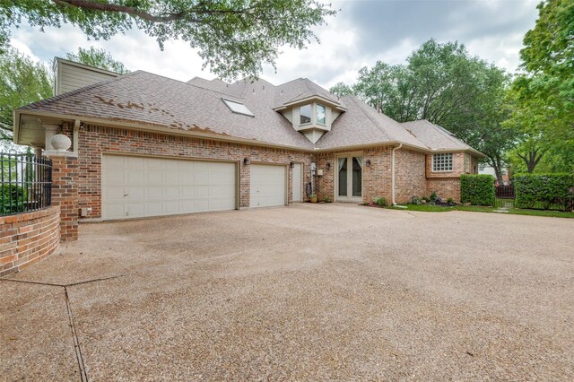 view of front of property featuring roof with shingles, a garage, brick siding, fence, and concrete driveway