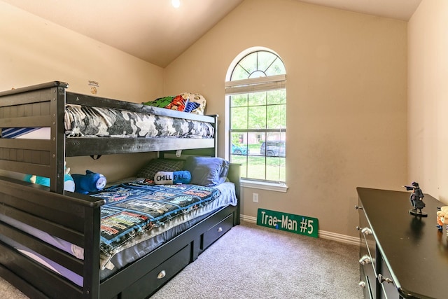carpeted bedroom featuring lofted ceiling and baseboards