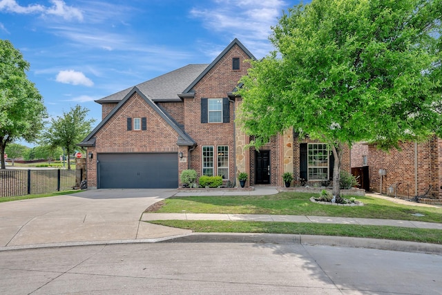 view of front of property featuring brick siding, driveway, fence, and roof with shingles