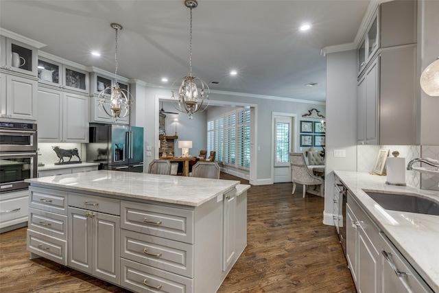 13998 Windham Dr, Van Alstyne, TX 75495 - kitchen featuring stainless steel appliances, crown molding, a kitchen island, tasteful backsplash, and recessed lighting