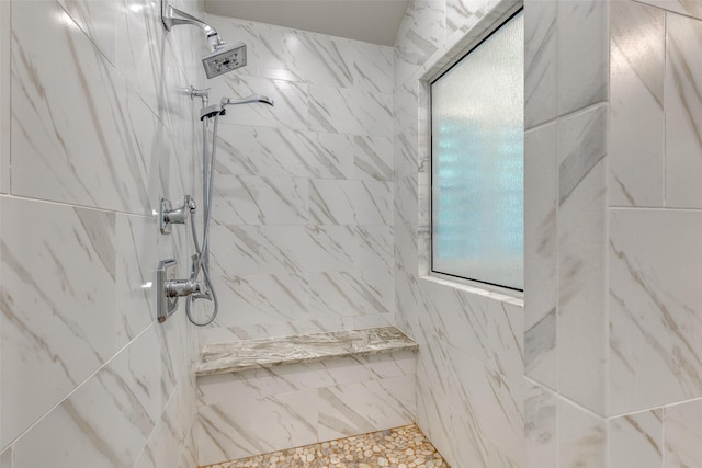 bathroom with a tile shower