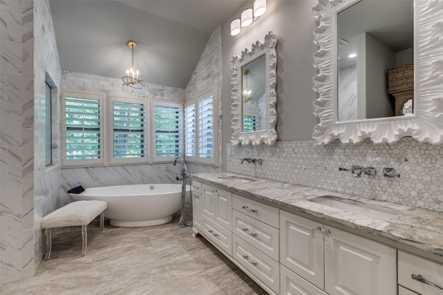 13998 Windham Dr, Van Alstyne, TX 75495 - full bathroom with tile walls, lofted ceiling, double vanity, a chandelier, and a freestanding bath