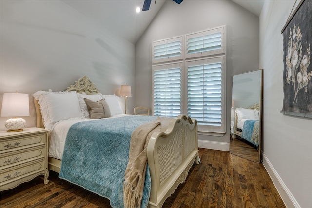bedroom featuring baseboards, wood finished floors, and high vaulted ceiling