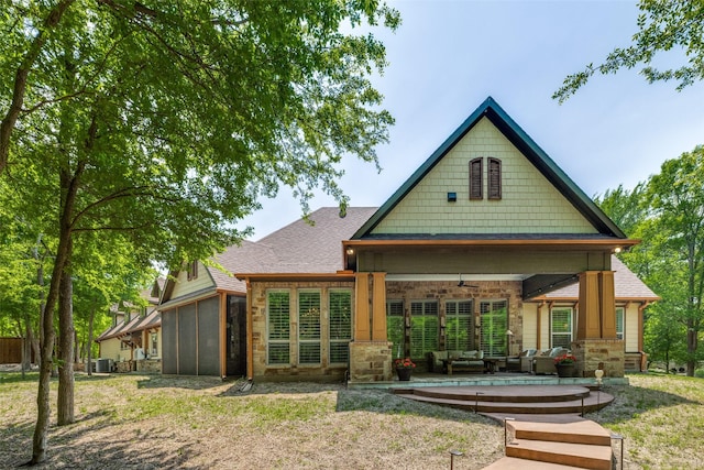 back of house featuring a shingled roof, an outdoor hangout area, central air condition unit, ceiling fan, and a sunroom