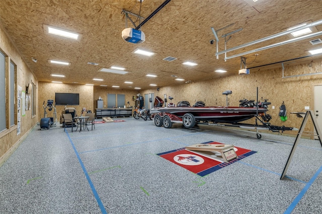 garage featuring a garage door opener and a workshop area