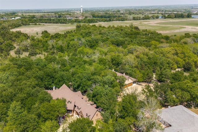 drone / aerial view featuring a wooded view
