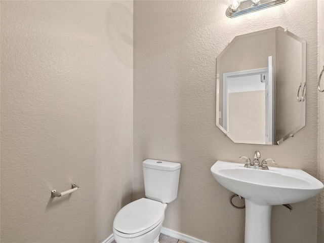 bathroom featuring toilet and a sink