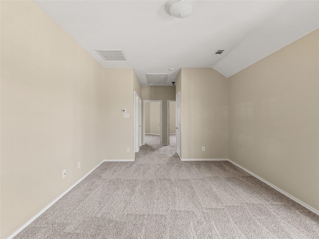 unfurnished bedroom with attic access, baseboards, visible vents, and carpet flooring