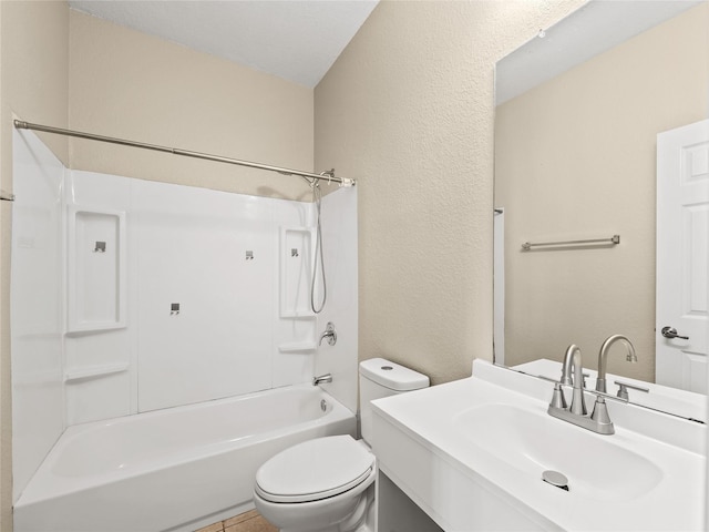 full bath with bathtub / shower combination, a textured wall, vanity, and toilet
