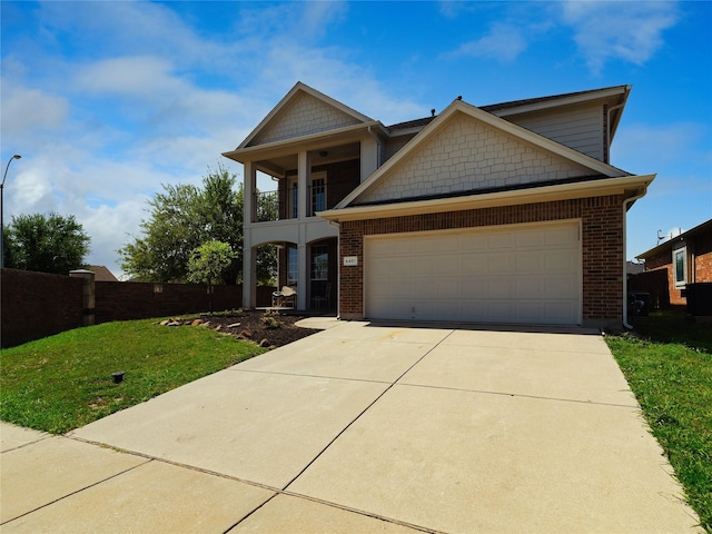 view of front facade with a balcony, a front lawn, an attached garage, fence, and brick siding