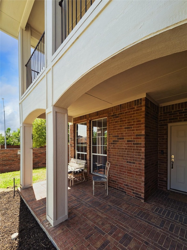 view of patio featuring a balcony