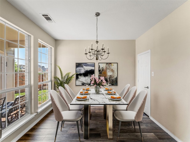 dining area with plenty of natural light, visible vents, a chandelier, and dark wood finished floors