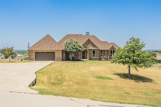 view of front of home with concrete driveway, a front lawn, brick siding, and a garage