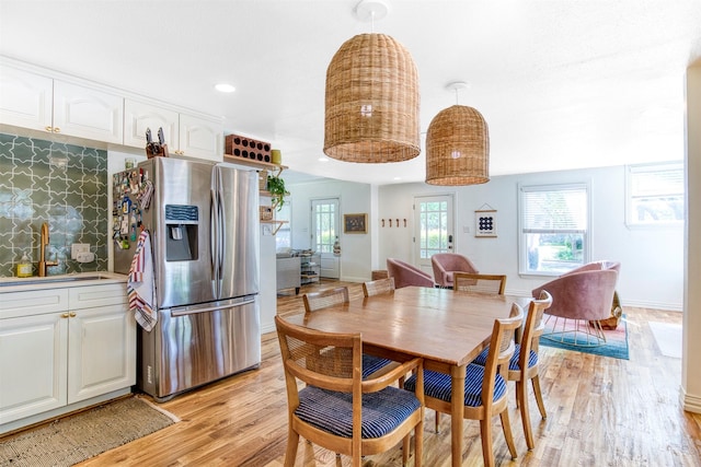 dining area featuring baseboards, recessed lighting, and light wood-style floors