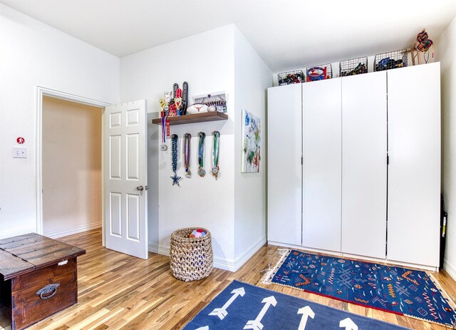 interior space with baseboards and light wood-style flooring