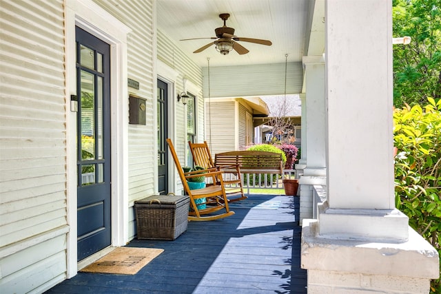 deck with a ceiling fan and a porch