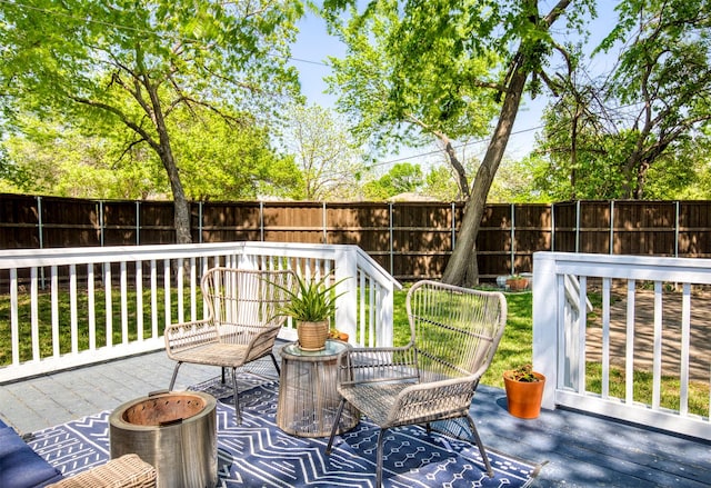 wooden terrace featuring a fenced backyard