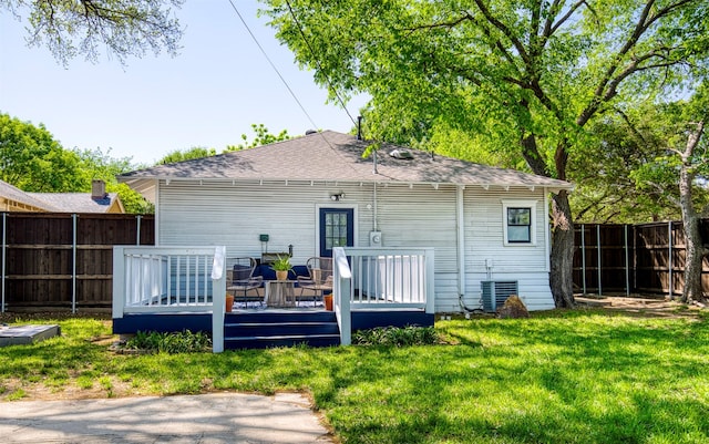back of house featuring a shingled roof, a fenced backyard, central AC, a lawn, and a deck