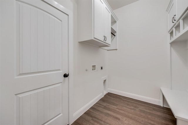 laundry room with hookup for a washing machine, electric dryer hookup, cabinet space, dark wood finished floors, and baseboards