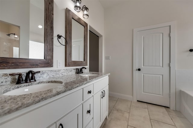 full bath featuring tile patterned flooring, a tub to relax in, a sink, and double vanity